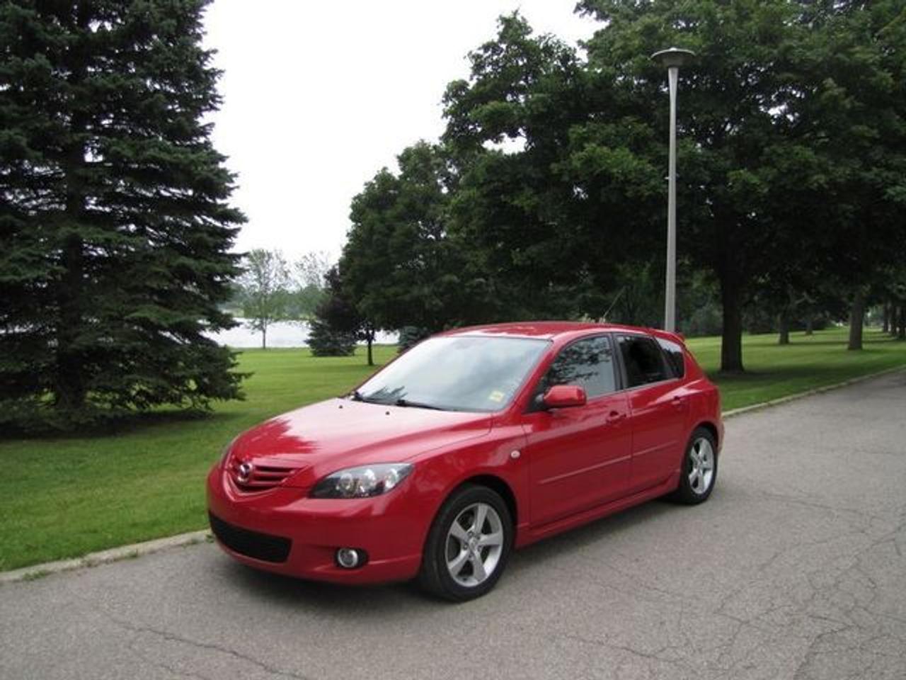 This 2006 Mazda MAZDA3 4dr GS SPORT HATCHBACK SPOILER!! MAZDA LEASE RETURN! Hatchback features a 2.3L L4 DOHC 16V 4 cyl Gasoline engine. It is equipped with a Automatic transmission. The vehicle is Red with a Black Cloth interior. It is offered with the remaining factory warranty. Over 400 BETTER used cars in stock!! PLEASE CALL 1-866-348-8146 5.99% Financing + no payments up to 6 months available on approved credit!! Free Trial Exchange!! A+ Better Business Bureau rating!! Voted Guelphs Favourite dealer 2004-2009!! Since 1961. Taxes, licensing, and $5.00 OMVIC fee are extra. Call for details on our Free Trial Exchange! Thank you for considering Wilsons!!! Please call 1-866-348-8146. - This Mazda is in Excellent overall exterior condition, Excellent overall interior condition, Cloth seats - Air Conditioning, Power Steering, Power Windows, Power Door Locks, Power Mirrors, Clock, Tachometer, Digital Info Center, Tilt Steering Wheel, Telescoping Steering Wheel, Driver Airbag, Passenger Airbag, Keyless Entry, ABS Brakes, Rear Defogger, Intermittent Wipers, AM-FM, Cassette, CD Player, Alloy Wheels, Sport Package, Cloth Interior Surface, Rear Spoiler, Rear Spoiler - Contact The Internet Department at 866-738-6045 or leads@markwilsonsbetterusedcarstc.dealer.com for more information. -