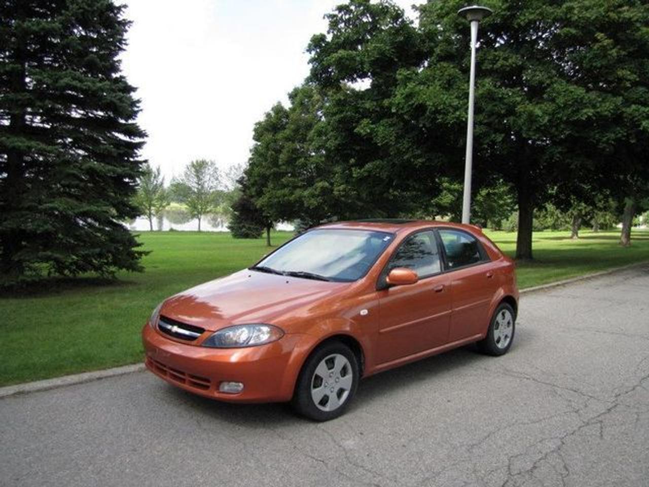 This 2007 Chevrolet Optra 5 4dr LT SUNROOF!! LOADED! GM LEASE RETURN!! Hatchback features a 2.0L L4 MPI DOHC 4 cyl Gasoline engine. It is equipped with a Automatic transmission. The vehicle is Atomic Orange Metallic with a Charcoal Cloth interior. It is offered with the remaining factory warranty. Over 400 Better used cars in stock!! PLEASE CALL 1-866-348-8146 A+ Better Business Bureau rating!! Voted Guelphs Favourite dealer 2004-2009!! Since 1961. Taxes, licensing and $5.00 OMVIC fee are extra. Better pictures at www.shopwilsons.com .WE ARE SELLING THIS ONE "AS IS" and we are required by law to state, even if this vehicle is perfect: &ldquo;Vehicle is not in roadworthy condition, not certified and not e-tested.&rdquo; THIS VEHICLE MAY EVEN HAVE MANUFACTURERS WARRANTY, AND IT MAY BE THE CAR FOR YOU, AT A PRICE YOU CAN AFFORD!!! SAFETY + E-TEST AVAILABLE FOR $595.00!!! - This Chevrolet is in Good overall exterior condition, Excellent overall interior condition, Cloth seats - Air Conditioning, Cruise Control, Power Steering, Power Windows, Power Door Locks, Power Mirrors, Clock, Tilt Steering Wheel, Driver Airbag, Passenger Airbag, Keyless Entry, ABS Brakes, Rear Defogger, Intermittent Wipers, AM-FM, CD Player, Wheels, Cloth Interior Surface - Contact The Internet Department at 866-738-6045 or leads@markwilsonsbetterusedcarstc.dealer.com for more information. -