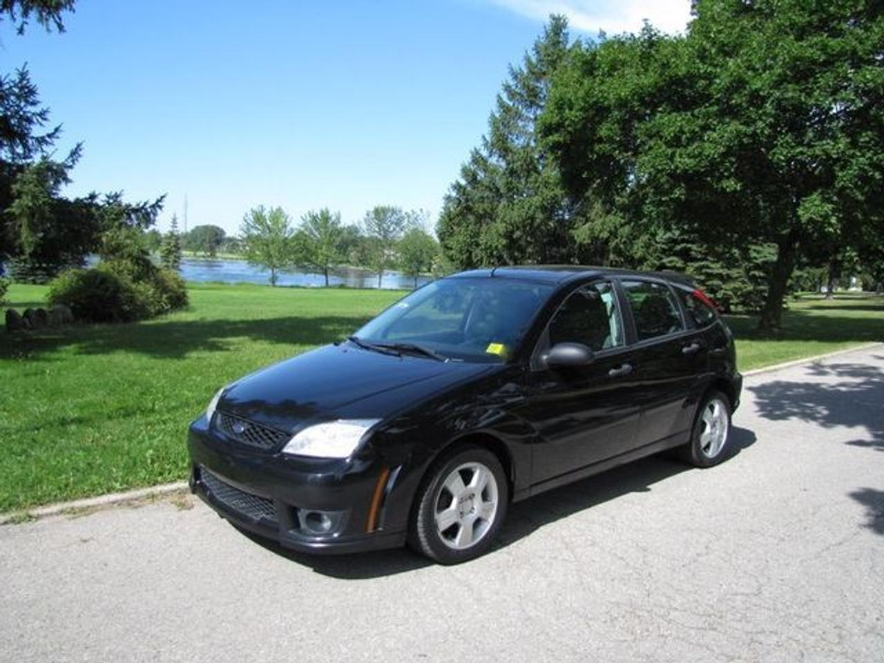 This 2006 Ford Focus 4dr ZX5 SES HATCHBACK FORD LEASE RETURN!! Hatchback features a 2.0L I4 FI DOHC 4 cyl Gasoline engine. It is equipped with a 5 Speed Manual transmission. The vehicle is Black with a Grey Cloth interior. It is offered with the remaining factory warranty. Over 400 BETTER used cars in stock!! PLEASE CALL 1-866-348-8146 5.74% Financing + no payments up to 6 months available on approved credit!! Free Trial Exchange!! A+ Better Business Bureau rating!! Voted Guelphs Favourite dealer 2004-2009!! Since 1961. Taxes, licensing, and $5.00 OMVIC fee are extra. Call for details on our Free Trial Exchange! Thank you for considering Wilsons!!! Please call 1-866-348-8146. - This Ford is in Excellent overall exterior condition, Excellent overall interior condition, Cloth seats - Air Conditioning, Cruise Control, Power Steering, Power Windows, Power Door Locks, Power Mirrors, Clock, Tachometer, Digital Info Center, Tilt Steering Wheel, Driver Airbag, Passenger Airbag, Keyless Entry, ABS Brakes, Rear Defogger, Intermittent Wipers, AM-FM, CD Player, Aluminum Wheels, Cloth Interior Surface - Contact The Internet Department at 866-738-6045 or leads@markwilsonsbetterusedcarstc.dealer.com for more information. -