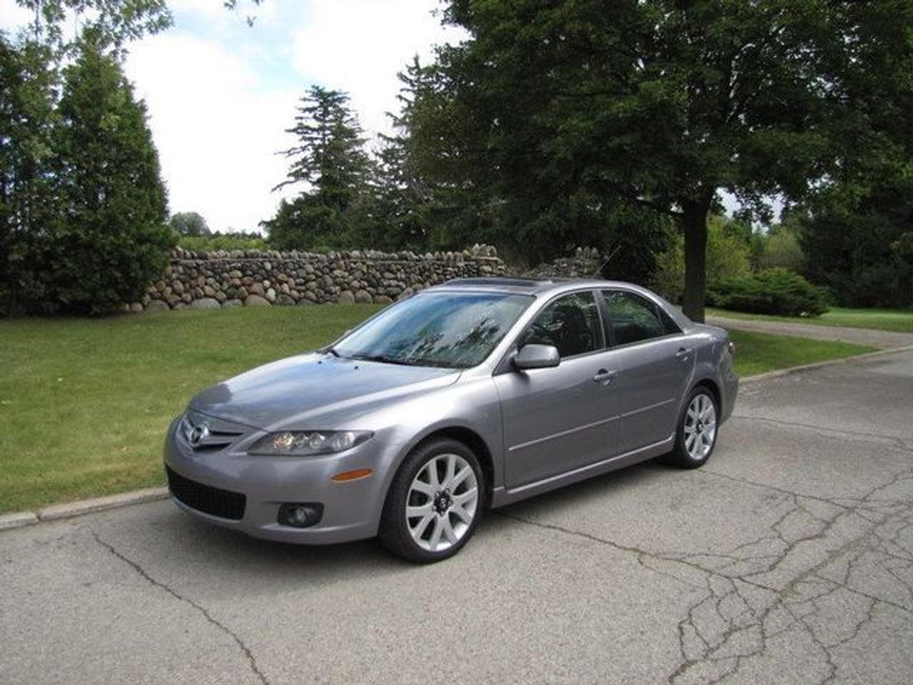 This 2007 Mazda MAZDA6 4dr GT V6 LEATHER-ROOF!! MAZDA LEASE RETURN!! Sedan features a 3.0L V6 DOHC 24V 6 cyl Gasoline engine. It is equipped with a Automatic transmission. The vehicle is Grey with a Black Leather interior. It is offered with the remaining factory warranty. Over 400 BETTER used cars in stock!! PLEASE CALL 1-866-348-8146 5.99% Financing + no payments up to 6 months available on approved credit!! Free Trial Exchange!! A+ Better Business Bureau rating!! Voted Guelphs Favourite dealer 2004-2009!! Since 1961. Taxes, licensing, and $5.00 OMVIC fee are extra. Call for details on our Free Trial Exchange! Thank you for considering Wilsons!!! Please call 1-866-348-8146. - This Mazda is in Excellent overall exterior condition, Excellent overall interior condition, Leather seats - Air Conditioning, Cruise Control, Power Steering, Power Windows, Power Door Locks, Power Mirrors, Power Drivers Seat, Power Passenger Seat, Heated Seat, Clock, Tachometer, Digital Info Center, Tilt Steering Wheel, Telescoping Steering Wheel, Sunroof, Driver Airbag, Passenger Airbag, Keyless Entry, ABS Brakes, Traction Control, Rear Defogger, Intermittent Wipers, AM-FM, CD Player, Aluminum Wheels, Leather Interior Surface - Contact The Internet Department at 866-738-6045 or leads@markwilsonsbetterusedcarstc.dealer.com for more information. -