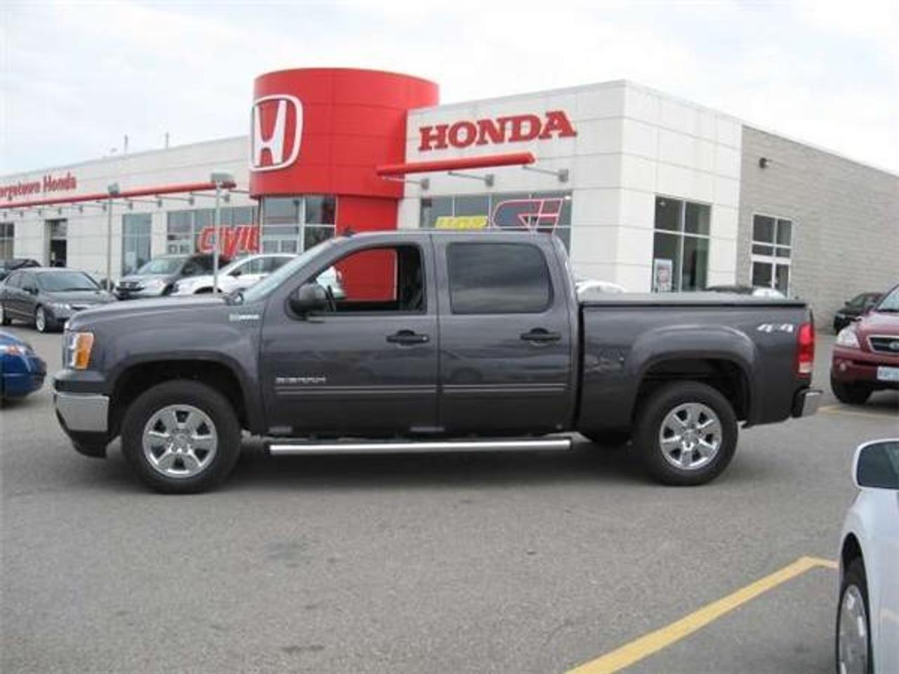 WOW WOW WHATTA TRUCK WHY BUY NEW ONLY 3905KMS COMPARE ANYWHERE BRAND NEW OVER $65K ABSOLUTELY LOADED WITH LEATHER SUNROF NAVIGATION BACK UP CAMERA CHROME SIDE STEPS TONEAU COVER ALL ORIGINAL FULL GM WARRANTY JUST ARRIVED COME GET IT WELL ITS HERE PRICE IS PLUS H.S.T SEE YOU SOON. 

Options

    AM/FM Stereo
    Adaptive Cruise Control
    Adjustable Pedals
    Air Conditioning
    All Equipped
    Alloy Wheels
    Anti-Lock Brakes
    Anti-Theft
    Backup Sensor
    Bose Sound System
    Box Liner
    CD Changer
    CD Player
    Crew Cab
    Cruise Control
    Curb Side Mirrors
    Daytime Running Lights
    Door Map Pockets
    Driver Side Airbag
    Dual Airbag
    Dual Climate Controls
    Fog Lights
    Heated Mirrors
    Heated Seats
    Intermittent Wipers
    Keyless Entry
    Leather Interior
    Leather Wrap Wheel
    Memory Seats
    Navigation System
    Off-Road Tires
    OnStar
    Passenger Airbag
    Power Brakes
    Power Locks
    Power Mirrors
    Power Seat
    Power Steering
    Power Sunroof
    Power Windows
    Premium Audio
    Privacy Glass
    Rear Defroster
    Rear Window Defogger
    Running Boards
    Side Impact Airbag
    Tilt Steering
    Tilt Wheel
    Tinted Glass
    Tinted Windows
    Tonneau Cover
    Tow Package
    Traction Control