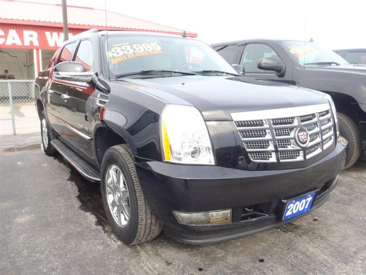 6.2L. V8.  THIS STUNNING BLACK ON TAN 2007 CADILLAC ESCALADEIS AN EXT LUXURY WITH THE FOLLOWING FEATURES.  TAN HEATED MEMORY LEATHER SEATS,FOG LIGHTS,RUNNING BOARDS,ROOF RACK,TONNEAU COVER,BACK UP SENSORS,TOW PACKAGE,POWER PEDAL,ONSTAR,DRIVERS LUMBAR SUPPORT,SUNROOF,LEATHER WRAPPED STEERING WHEEL WITH CONTROLS,18 CHROME TIRES,C/D -6. LOADED!!!  30 Years in business, A+ BBB rated company, 200 units in stock, 2 locations.  Home of the Warranty for Life, full service department, on the spot financing.    Bad credit welcomed.    Winner of Reader Choice Award for the best dealer in the Listowel area.   Winner Of Business Of The Year Award from the North Perth Chamber Of Commerce!   Free carproof or carfax.    No extra fees no extra costs.    All prices + HST & Licensing.    Save money!   (Thanks for shopping at STOP23 AUTO SALES LTD).