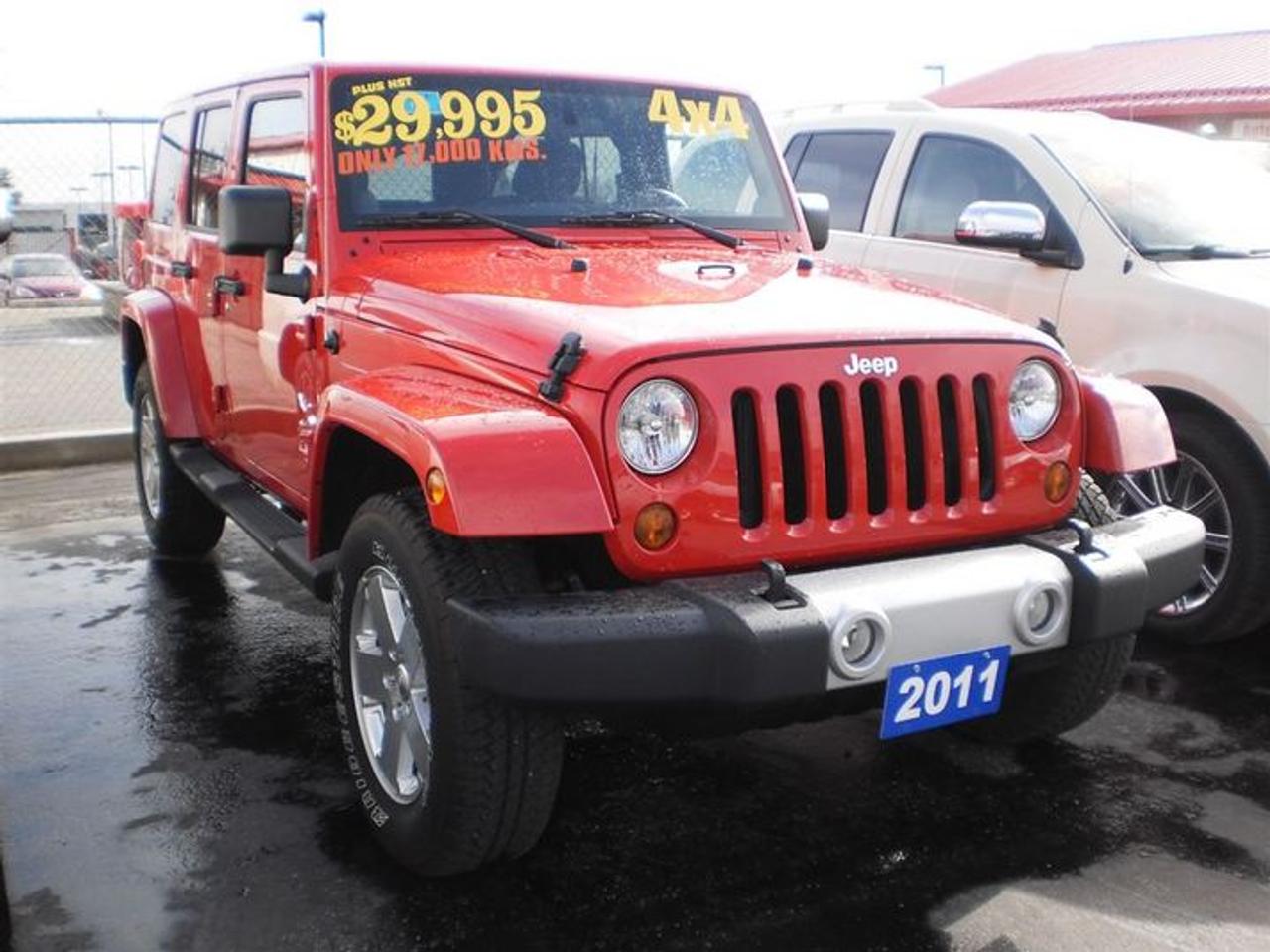 3.8L. V6.  2011 JEEP WRANGLER UNLIMITED SAHARA IN A STUNNING SHADE OF RED WITH BLACK CLOTH INTERIOR AND COMES WITH THE FOLLOWING FEATURES.  RUNNING BOARDS,FOG LIGHTS,HEATED MIRRORS,LEATHER WRAPPED STEERING WHEEL WITH CONTROLS, AND MUCH MORE!    30 Years in business, A+ BBB rated company, 200 units in stock, 2 locations.  Home of the Warranty for Life, full service department, on the spot financing.    Bad credit welcomed.    Winner of Reader Choice Award for the best dealer in the Listowel area.   Winner Of Business Of The Year Award from the North Perth Chamber Of Commerce!   Free carproof or carfax.    No extra fees no extra costs.    All prices + HST & Licensing.    Save money!   (Thanks for shopping at STOP23 AUTO SALES LTD).