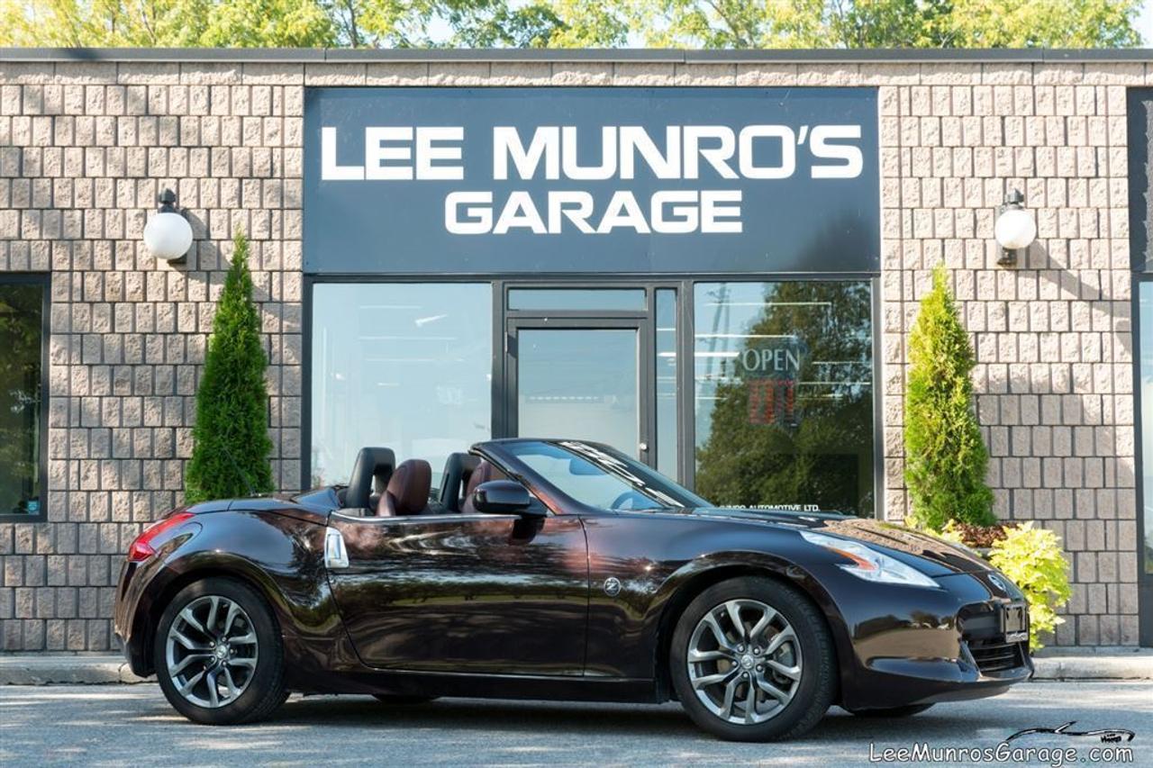 Thoroughly inspected, Certified, E-tested, Clean Carproof. Tight styling, Powerful, 332-horsepower V-6, Paddle-shifted automatic, Solid performance/dollar ratio, with an array of advanced technology including push button start, Bose audio system, as well as customer-friendly features such as the one-touch fully automatic roof operation, and Bluetooth connectivity. With its lightening quick acceleration, the 370Z roadster is kept on the road by 19-inch lightweight aluminum alloy wheels and pulled up by the Nissan Premium Braking System &ndash; which includes Anti-Lock Braking System, with Electronic Brake force Distribution, and Brake Assist. What a great buy on a great car! We can assist with bank financing, credit union and leasing from 4.9% on approved credit.