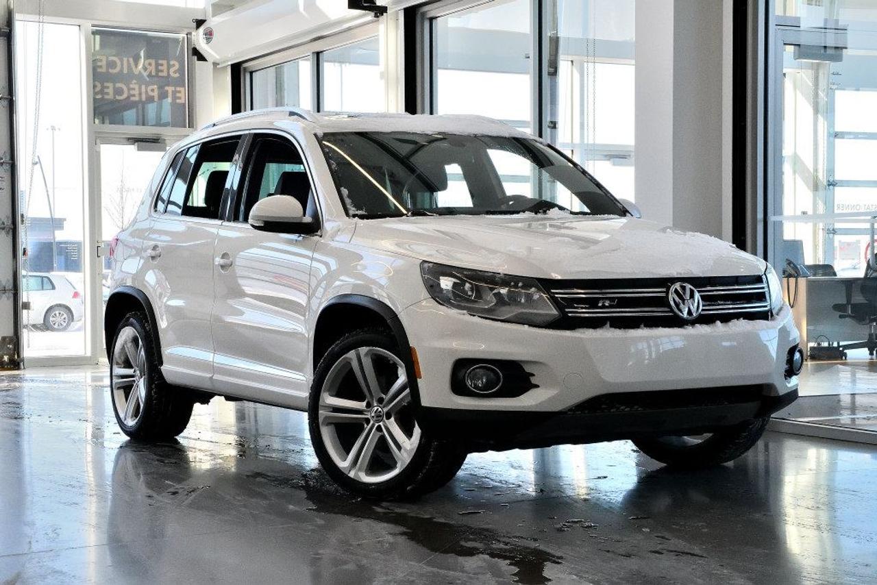 <a href=https://www.vaudreuilvolkswagen.com/occasion/Volkswagen-Tiguan-2014.html>https://www.vaudreuilvolkswagen.com/occasion/Volkswagen-Tiguan-2014.html</a>

Modèle Highline R-Line 4motion avec intérieur en cuir noir. Roues 19, Toit panoramique, écran multimédia, , sièges électriques avec mémoire, lumière automatiques, navigation, système audio Dynaudio, caméra de recul, climatisation deux-zones et essuie-glaces automatiques. Retour de location, jamais accidenté.        Possibilité dextension de 2 ans ou 40 000 kms de la garantie dorigine avec la certification supérieure Volkswagen        Aucunes obligations bancaires, aucuns frais cachés        Mise en service : 9 Décembre 2013    Bienvenue chez Vaudreuil Volkswagen!