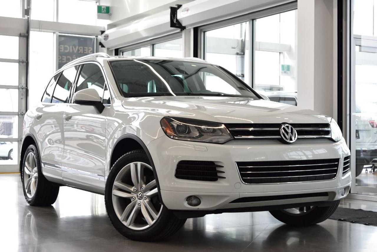 <a href=https://www.vaudreuilvolkswagen.com/occasion/Volkswagen-Touareg-2014.html>https://www.vaudreuilvolkswagen.com/occasion/Volkswagen-Touareg-2014.html</a>

Modèle Comfortline avec ensemble sport et ensemble toit ouvrant panoramique. Roues de 20, phares bi-xénon avec accents LED, hayon électrique, intérieur en similicuir, climatisation double-zones, caméra de recul, navigation. Échange dun client de la maison, jamais accidenté.        Aucunes obligations bancaires, aucuns frais cachés        Mise en service : 15 août 2014        Bienvenue chez Vaudreuil Volkswagen!