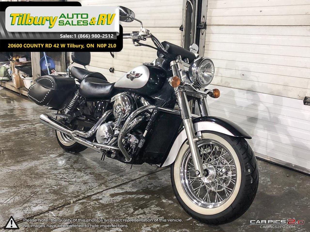 <p><span style=font-size: medium;><strong><span style=font-family: Verdana, sans-serif;>Call us at 519-682-2407 or visit our lot at 20600 HWY #42, Tilbury, Ontario. Canada.</span></strong></span></p>
<p><span style=font-size: medium;>This fuel-injected, liquid cooled, SOHC design displaces 90 cubic inches and shines with elegantly sculpted cylinders and polished cooling fins, while the large radiator is tucked from view between the frame downtubes.</span></p>
<p><span style=font-size: medium;>Both of the big V-twin&rsquo;s cylinders have four valves actuated by a single overhead cam (SOHC). Hydraulic valve lash adjusters automatically maintain valve clearance for smooth engine performance, reduced noise and low maintenance while automatic cam chain tensioners keep cam timing accurate.</span><br /><br /><span style=font-size: medium;>The engine produces a distinct V-twin rumble and more than 85 foot-pounds of torque at 3,000 rpm. A crack of the throttle punches out smooth acceleration while a large alternator provides enough output to power electrical accessories.<br /><br /></span><strong style=font-size: medium;><span style=font-family: Verdana, sans-serif;>Call us at 519-682-2407 or visit our lot at 20600 HWY #42, Tilbury, Ontario. Canada.</span></strong></p>
<p class=MsoNormal style=mso-margin-top-alt: auto; mso-margin-bottom-alt: auto; line-height: normal;><span style=font-size: 7.5pt; font-family: Verdana, sans-serif;>While every reasonable effort is made to ensure the accuracy of this data, we are not responsible for any errors or omissions contained on these pages. Please verify any information in question with a dealership sales representative. Please call for further details. While every reasonable effort is made to ensure the accuracy of this data, we are not responsible for any errors or omissions contained on these pages. Please verify any information in question with a dealership sales representative. Serving, Windsor, Essex, Tilbury, Chatham, Blenheim, Rodney, St. Marys, St. Thomas, Leamington, Harrow, Amherstburg, Kingsville, Wheatley, Belle River, Lakeshore, Wallaceburg, Sarnia,London, Lambton, Lambton County, Lambeth, Essex County, Middlesex, Middlesex County, Rodney, Dresden, Thamesville, Lasalle, Watford, Ailsa Craig, Glencoe, Alvinston, Parkhill, Strathroy, Mt.Brydges, West Lorne, Dutton, Aylmer * Prices in Ontario, include OMVIC/AMVIC fee (where applicable), dealer administration and other retailer charges and exclude taxes, license, insurance, plus HST*</span></p>