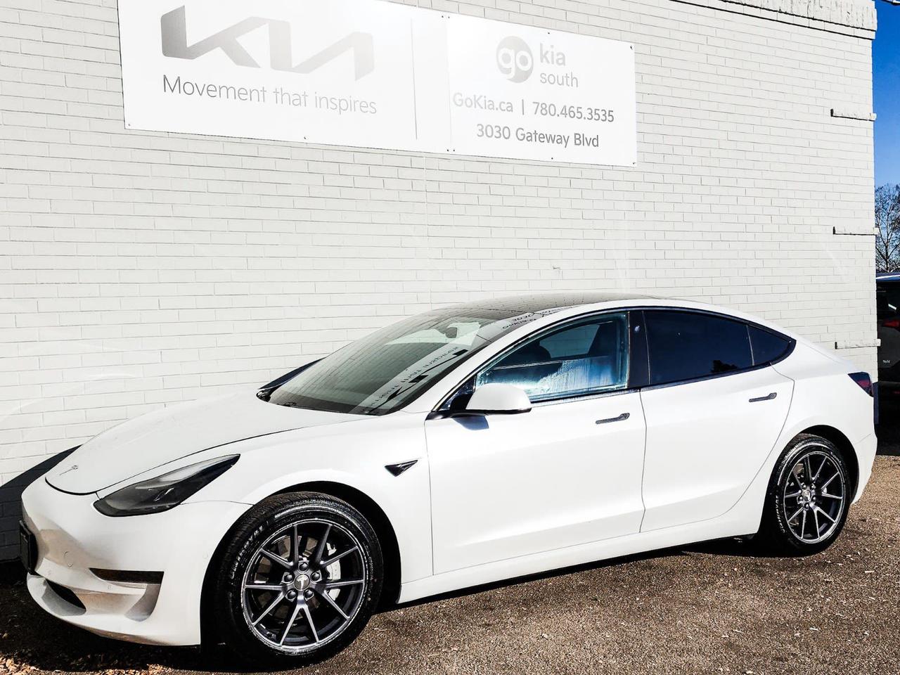 Recent Arrival! White 2021 Tesla Model 3 Standard Range Plus RWD 1-Speed Automatic Electric Motor4-Wheel Disc Brakes, 8 Speakers, ABS brakes, Air Conditioning, Alloy wheels, Auto High-beam Headlights, Auto-dimming door mirrors, Auto-dimming Rear-View mirror, Automatic temperature control, Brake assist, Bumpers: body-colour, Compass, Delay-off headlights, Driver door bin, Driver vanity mirror, Dual front impact airbags, Dual front side impact airbags, Electronic Stability Control, Exterior Parking Camera Rear, Four wheel independent suspension, Front anti-roll bar, Front Bucket Seats, Front dual zone A/C, Front reading lights, Fully automatic headlights, Genuine wood dashboard insert, Heated door mirrors, Heated Front Bucket Seats, Heated front seats, Heated rear seats, Heated steering wheel, Illuminated entry, Knee airbag, Low tire pressure warning, Memory seat, Navigation System, Occupant sensing airbag, Outside temperature display, Overhead airbag, Passenger door bin, Passenger vanity mirror, Power door mirrors, Power driver seat, Power passenger seat, Power steering, Power windows, Premium Seat Trim, Radio data system, Radio: Upgraded Audio System, Rear reading lights, Rear window defroster, Remote keyless entry, Security system, Speed control, Speed-sensing steering, Split folding rear seat, Steering wheel memory, Steering wheel mounted A/C controls, Steering wheel mounted audio controls, Telescoping steering wheel, Tilt steering wheel, Traction control, Trip computer, Wheels: 18 x 8.5 Aero.IN HOUSE FINANCING, IN HOUSE LEASING AVAILABLE O.A.C.If you are interested and need more information call or message our sales team, we will be glad to help you now!!Our knowledgeable sales staff will help assist you with every step. To book a test drive or receive further information give us a call at (780)-465-3535 or email us: kiahmed@gokia.caAt Go Kia, were happy to help! Proudly serving Edmonton and all of Alberta including St. Albert, Wetaskiwin, Fort McMurray, Grande Prairie, Drayton Valley, Nisku, Leduc, Rimby, Hinton, St. Paul, Lloydminster, Edson, and all of Western Canada!An AMVIC Licensed Business. Value Priced vehicles are aggressively priced and may require some additional mechanical or cosmetic repairs, all disclosed on a Vehicle Assessment Report!This vehicle may be leased or financed by anyone*, however, due to the recent increase in fraudulent vehicle purchase activity, Go Kia reserves the right to decline a transaction on suspicion of non-retail intentions including but not limited to wholesaling or exporting.*on approved credit, see dealer for details