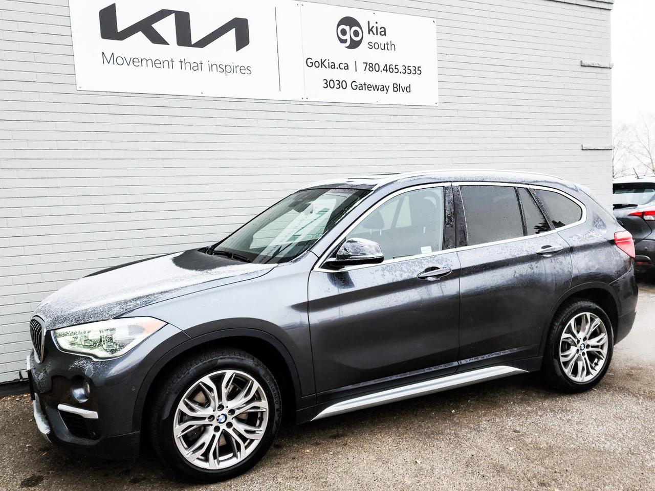 Recent Arrival! Odometer is 33335 kilometers below market average! Gray 2018 BMW X1 xDrive28i AWD 8-Speed Automatic 2.0L 4-Cylinder DOHC 16V TwinPower Turbo3.20 Axle Ratio, 4-Wheel Disc Brakes, 6 Speakers, ABS brakes, Air Conditioning, Alloy wheels, AM/FM radio, Automatic temperature control, BMW Assist Emergency Call, BMW TeleServices, Brake assist, Bumpers: body-colour, CD player, Compass, Delay-off headlights, Driver door bin, Driver vanity mirror, Dual front impact airbags, Dual front side impact airbags, Electric Seats w/Driver Memory, Electronic Stability Control, Emergency communication system: BMW Assist eCall, Exterior Parking Camera Rear, Four wheel independent suspension, Front anti-roll bar, Front Bucket Seats, Front dual zone A/C, Front fog lights, Front reading lights, Genuine wood dashboard insert, Genuine wood door panel insert, Heated door mirrors, Heated Front Bucket Seats, Heated front seats, Illuminated entry, In Dash CD Player, Knee airbag, Leather Shift Knob, Leatherette Upholstery, Low tire pressure warning, Memory seat, Navigation System, Occupant sensing airbag, Outside temperature display, Overhead airbag, Panorama Sunroof, Passenger door bin, Passenger vanity mirror, Power door mirrors, Power driver seat, Power passenger seat, Power steering, Power windows, Radio data system, Radio: Professional w/6.5 Control Display, Rain sensing wipers, Rear anti-roll bar, Rear Parking Sensors, Rear reading lights, Rear window defroster, Rear window wiper, Remote keyless entry, Speed control, Speed-sensing steering, Speed-Sensitive Wipers, Split folding rear seat, Spoiler, Steering wheel mounted audio controls, Tachometer, Telescoping steering wheel, Tilt steering wheel, Traction control, Trip computer, Turn signal indicator mirrors, Variably intermittent wipers, Wheels: 18 x 7.5 Light Alloy Y-Spoke (Style 556).Reviews: * Most owners report that the X1 is easy to enter and exit, offers sufficient space for four adults and their things, and delivers a sturdy road feel with good ride comfort, while the all-wheel drive system adds plenty of confidence and control when used in inclement weather  provided appropriate tires are installed, of course. A pleasing blend of performance and fuel economy are also reported by most owners. Check out the video below for our impressions of the second-generation X1 when it launched in 2016. Source: autoTRADER.caIN HOUSE FINANCING, IN HOUSE LEASING AVAILABLE O.A.C.If you are interested and need more information call or message our sales team, we will be glad to help you now!!Our knowledgeable sales staff will help assist you with every step. To book a test drive or receive further information give us a call at (780)-465-3535 or email us: kiahmed@gokia.caAt Go Kia, were happy to help! Proudly serving Edmonton and all of Alberta including St. Albert, Wetaskiwin, Fort McMurray, Grande Prairie, Drayton Valley, Nisku, Leduc, Rimby, Hinton, St. Paul, Lloydminster, Edson, and all of Western Canada!An AMVIC Licensed Business. Value Priced vehicles are aggressively priced and may require some additional mechanical or cosmetic repairs, all disclosed on a Vehicle Assessment Report!This vehicle may be leased or financed by anyone*, however, due to the recent increase in fraudulent vehicle purchase activity, Go Kia reserves the right to decline a transaction on suspicion of non-retail intentions including but not limited to wholesaling or exporting.*on approved credit, see dealer for details