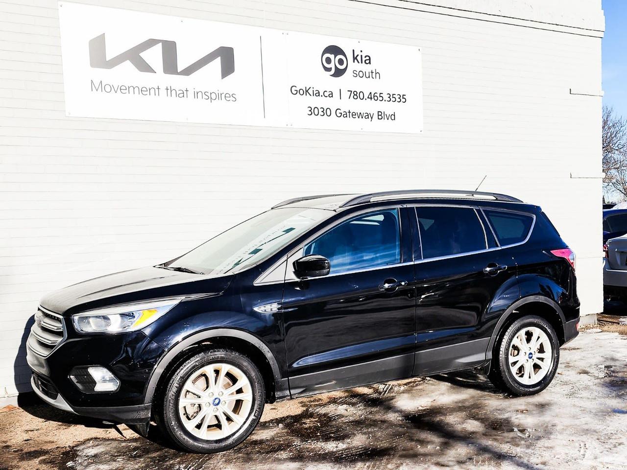 <p>Recent Arrival! Black 2018 Ford Escape SE 4WD 6-Speed Automatic 1.5L EcoBoost4WD, 3.51 Axle Ratio, 4-Wheel Disc Brakes, 6 Speakers, ABS brakes, Air Conditioning, Alloy wheels, AM/FM radio: SiriusXM, Automatic temperature control, Block heater, Brake assist, Bumpers: body-colour, CD player, Compass, Delay-off headlights, Driver door bin, Driver vanity mirror, Dual front impact airbags, Dual front side impact airbags, Electronic Stability Control, Emergency communication system: 911 Assist, Exterior Parking Camera Rear, Four wheel independent suspension, Front anti-roll bar, Front Bucket Seats, Front dual zone A/C, Front fog lights, Front reading lights, Fully automatic headlights, Heated Cloth Front Bucket Seats, Heated door mirrors, Heated front seats, Illuminated entry, Knee airbag, Low tire pressure warning, Occupant sensing airbag, Outside temperature display, Overhead airbag, Overhead console, Panic alarm, Passenger door bin, Passenger vanity mirror, Power door mirrors, Power driver seat, Power steering, Power windows, Radio data system, Radio: AM/FM Single-CD/MP3 Capable, Rear anti-roll bar, Rear window defroster, Rear window wiper, Remote keyless entry, Roof rack: rails only, Security system, Speed control, Speed-sensing steering, Split folding rear seat, Steering wheel mounted audio controls, SYNC Communications & Entertainment System, Tachometer, Telescoping steering wheel, Tilt steering wheel, Traction control, Trip computer, Variably intermittent wipers, Wheels: 17 Sparkle-Painted Aluminum.Reviews: * Owners appreciate a modern and unique cabin layout, peace of mind in bad weather, and pleasing performance from the turbocharged engines, particularly the larger 2.0L unit. Controls are said to be easy to use, and interfaces are easily learned. Plenty of at-hand storage is fitted within reach of all occupants to help keep organized and tidy on the move, and the tall and upright driving position helps add confidence. Good brake feel is also noted, particularly during hard stops. Source: autoTRADER.caIN HOUSE FINANCING, IN HOUSE LEASING AVAILABLE O.A.C.If you are interested and need more information call or message our sales team, we will be glad to help you now!!Our knowledgeable sales staff will help assist you with every step. To book a test drive or receive further information give us a call at (780)-465-3535 or email us: kiahmed@gokia.caAt Go Kia, were happy to help! Proudly serving Edmonton and all of Alberta including St. Albert, Wetaskiwin, Fort McMurray, Grande Prairie, Drayton Valley, Nisku, Leduc, Rimby, Hinton, St. Paul, Lloydminster, Edson, and all of Western Canada!An AMVIC Licensed Business. Value Priced vehicles are aggressively priced and may require some additional mechanical or cosmetic repairs, all disclosed on a Vehicle Assessment Report!This vehicle may be leased or financed by anyone*, however, due to the recent increase in fraudulent vehicle purchase activity, Go Kia reserves the right to decline a transaction on suspicion of non-retail intentions including but not limited to wholesaling or exporting.*on approved credit, see dealer for details</p>