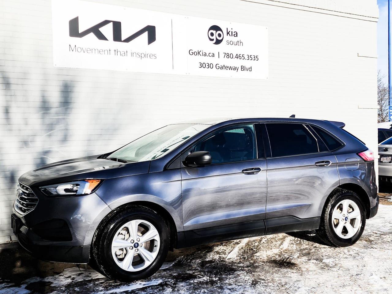 Recent Arrival! Gray 2022 Ford Edge SE AWD 8-Speed Automatic EcoBoost 2.0L I4 GTDi DOHC Turbocharged VCTAWD, 3.36 Axle Ratio, 4-Wheel Disc Brakes, 6 Speakers, ABS brakes, Active Transmission Warm-Up, Air Conditioning, Alloy wheels, AM/FM radio: SiriusXM with 360L, Auto High-beam Headlights, Automatic temperature control, Block heater, Brake assist, Bumpers: body-colour, Compass, Delay-off headlights, Driver door bin, Driver vanity mirror, Dual front impact airbags, Dual front side impact airbags, Electronic Stability Control, Emergency communication system: SYNC 4 911 Assist, Four wheel independent suspension, Front anti-roll bar, Front Bucket Seats, Front Cloth Bucket Seats, Front dual zone A/C, Front reading lights, Fully automatic headlights, Illuminated entry, Knee airbag, Low tire pressure warning, Occupant sensing airbag, Outside temperature display, Overhead airbag, Overhead console, Panic alarm, Passenger door bin, Passenger vanity mirror, Power door mirrors, Power steering, Power windows, Radio: AM/FM Stereo/MP3 Capable, Rear anti-roll bar, Rear reading lights, Rear window defroster, Rear window wiper, Remote keyless entry, Speed control, Speed-Sensitive Wipers, Split folding rear seat, Spoiler, Steering wheel mounted audio controls, SYNC 4A w/Enhanced Voice Recognition, Tachometer, Telescoping steering wheel, Tilt steering wheel, Traction control, Trip computer, Variably intermittent wipers, Wheels: 18 Sparkle Silver-Painted Aluminum.IN HOUSE FINANCING, IN HOUSE LEASING AVAILABLE O.A.C.If you are interested and need more information call or message our sales team, we will be glad to help you now!!Our knowledgeable sales staff will help assist you with every step. To book a test drive or receive further information give us a call at (780)-465-3535 or email us: kiahmed@gokia.caAt Go Kia, were happy to help! Proudly serving Edmonton and all of Alberta including St. Albert, Wetaskiwin, Fort McMurray, Grande Prairie, Drayton Valley, Nisku, Leduc, Rimby, Hinton, St. Paul, Lloydminster, Edson, and all of Western Canada!An AMVIC Licensed Business. Value Priced vehicles are aggressively priced and may require some additional mechanical or cosmetic repairs, all disclosed on a Vehicle Assessment Report!This vehicle may be leased or financed by anyone*, however, due to the recent increase in fraudulent vehicle purchase activity, Go Kia reserves the right to decline a transaction on suspicion of non-retail intentions including but not limited to wholesaling or exporting.*on approved credit, see dealer for details