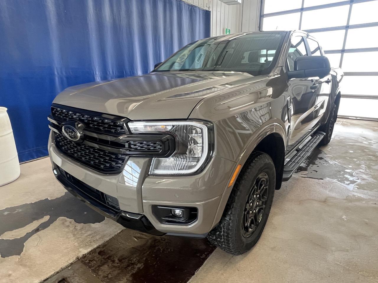 <p><strong>The 2026 Ford Ranger XLT Crew Cab at Merit Ford Sales is built for those who demand capability without compromise.</strong> Finished in Marsh Grey with a Black Appearance Package, this 4WD truck pairs a punchy 2.7L 6-cylinder engine with a full suite of modern safety and convenience tech making it equally at home on the job site or the weekend trail.<br><br>- 2.7L 6-cylinder engine with 4WD and automatic transmission for serious towing and off-road capability<br>- Black Appearance Package (76J) for an aggressive, blacked-out exterior look unique to this build<br>- Trailer Tow Package (53R) with BLIS Blind Spot Monitoring specifically covering trailer tow scenarios<br>- Engine Block Heater (41H) a practical must-have for Canadian winters, already installed<br>- Black Running Boards (18D) for easy cab entry and a cohesive exterior appearance<br>- Collision Mitigation, Driver Monitoring Alert, and Reverse Brake Assist for confident driving in all conditions<br>- Crew Cab short bed layout seating 5 passengers with a fold-up rear bench versatile for passengers and cargo<br>- Fuel economy of 10 L/100 km highway with city-friendly automatic headlights, fog lamps, and heated rear defroster<br><br>Ready to put this Ranger to work? Visit Merit Ford Sales to book a test drive, ask our team any questions, or get started on your purchase today in person or online.</p>